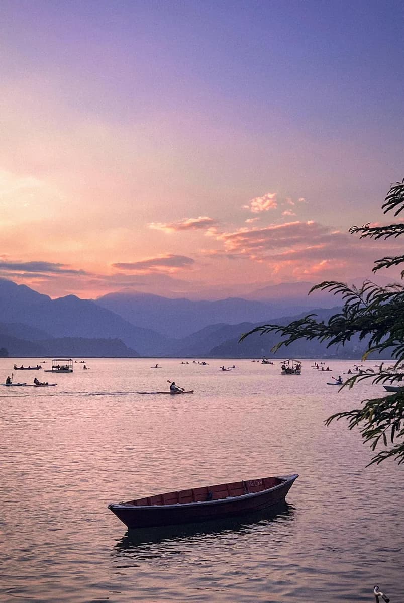 Boats on Phewa Lake at dusk, Pokhara, Nepal